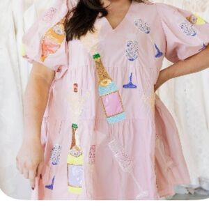 QOS Pink Ruffle Sleeve Dress with champagne bottles and glasses!